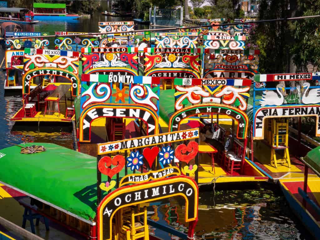 Aerial view of colorful boats floating on water.