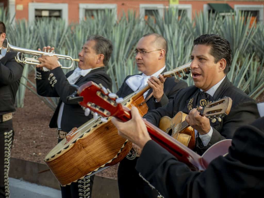 A group of people playing instruments and performing on a stage