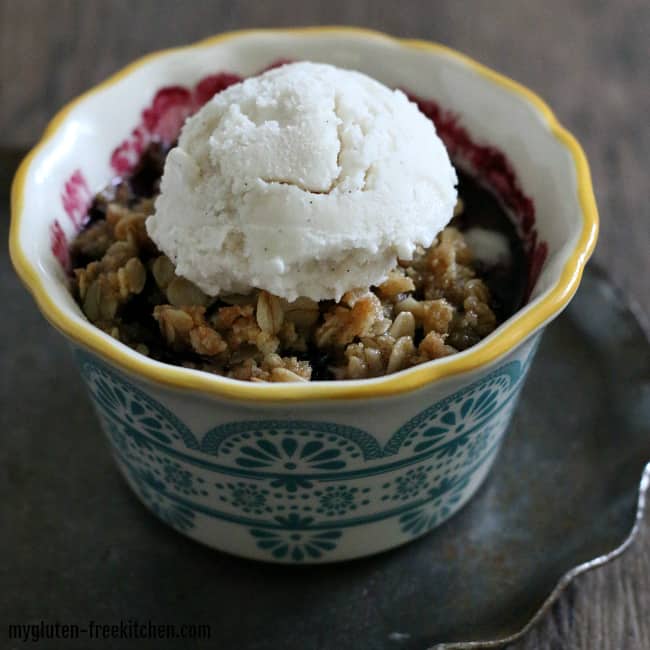 A bowl has dessert and a scoop of ice cream on it.