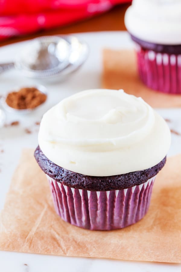 Close up of a cupcake with white frosting.