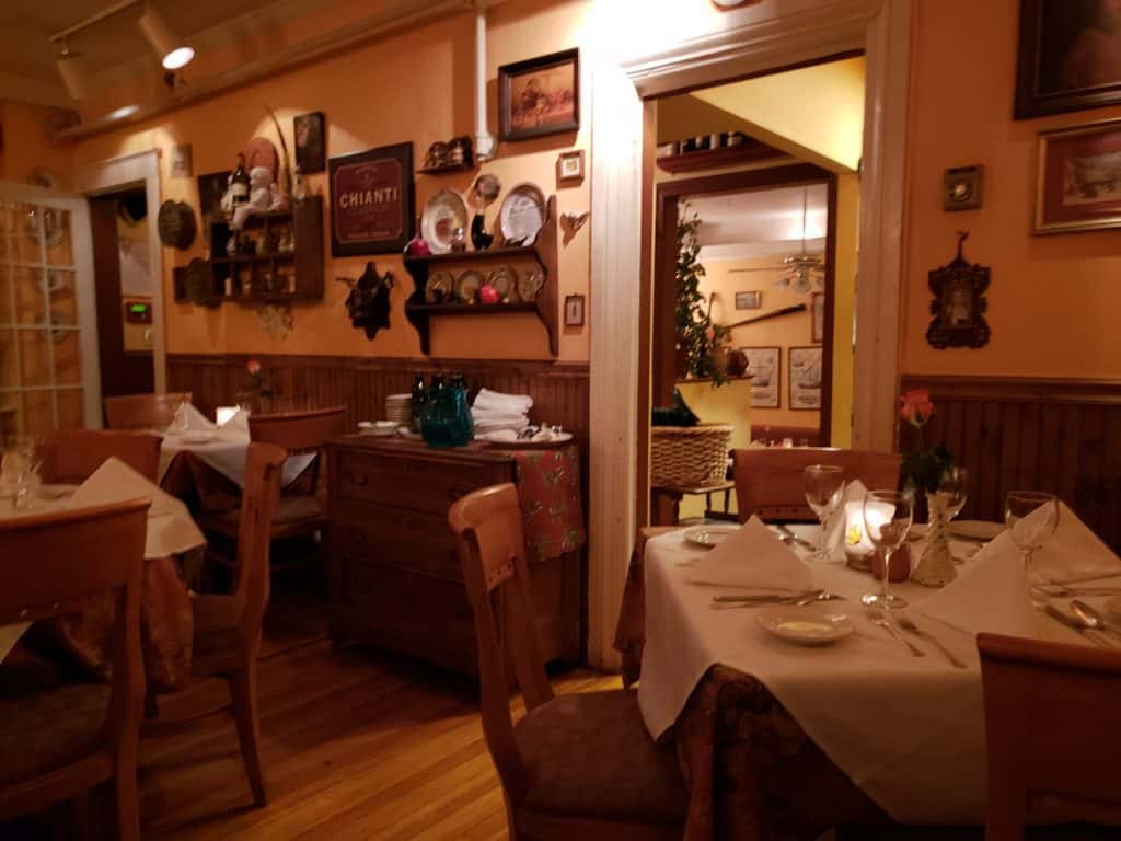 Interior of a dining room with eclectic decor on the wall.