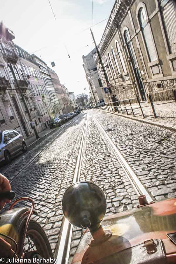 Cobblestone street lined by shops.