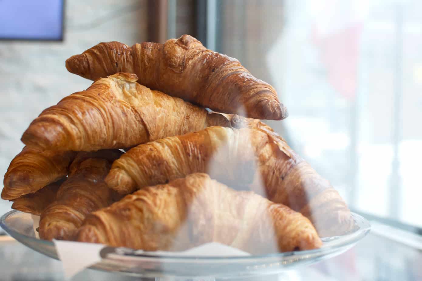 A pile of croissants on a plate