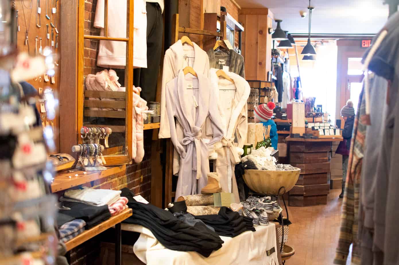 Interior of a shop with bathrobes hanging and folded clothes on a table in Portsmouth New Hampshire