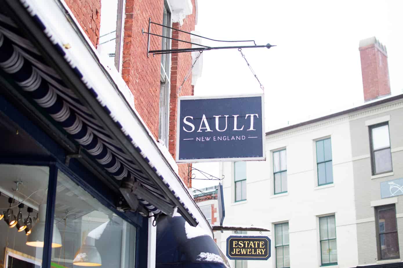 Row of stores with a sign hanging that reads \"Sault\" in Portsmouth New Hampshire