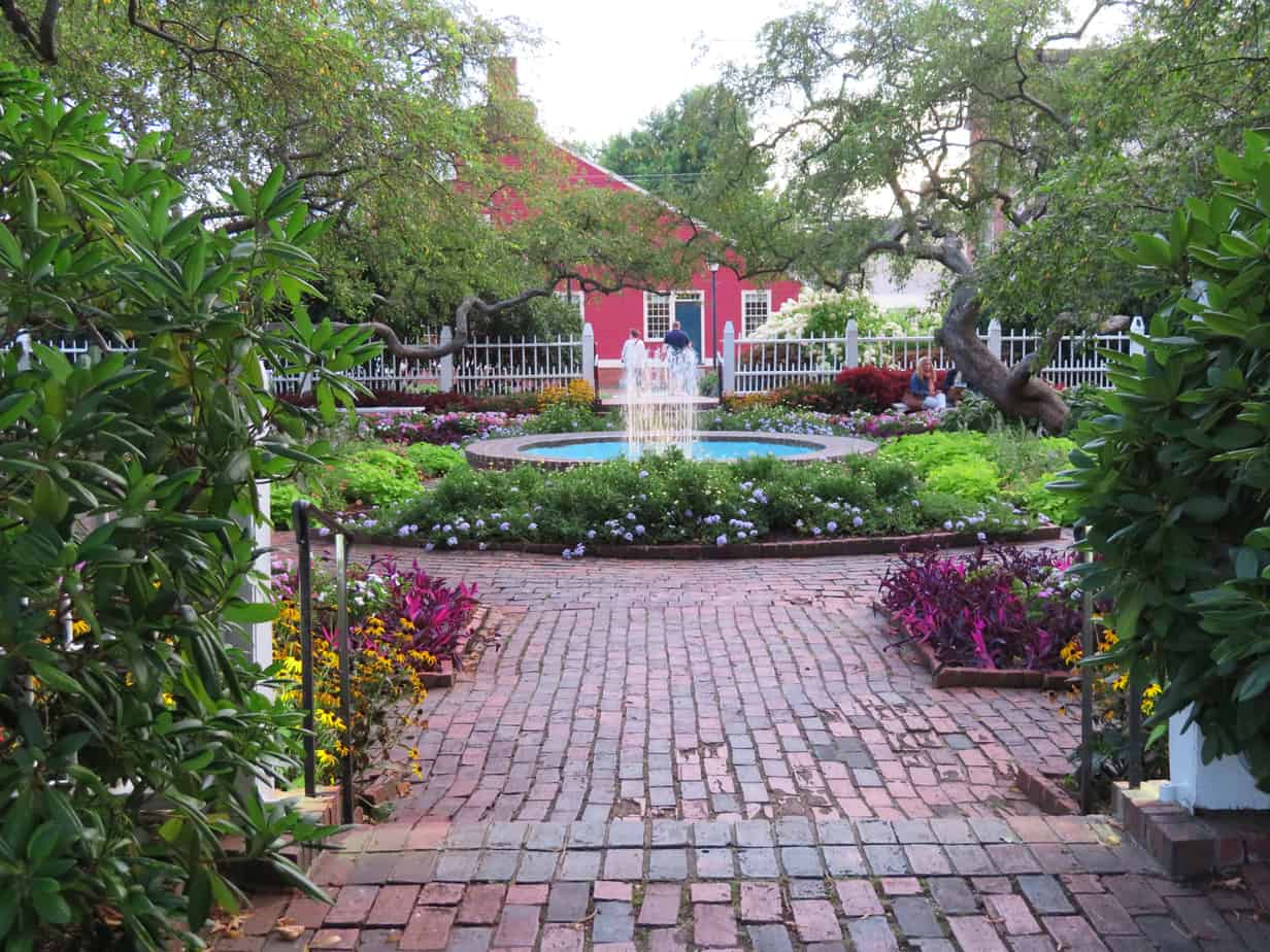 View outward toward a garden and a red farmhouse in the distance in Portsmouth New Hampshire