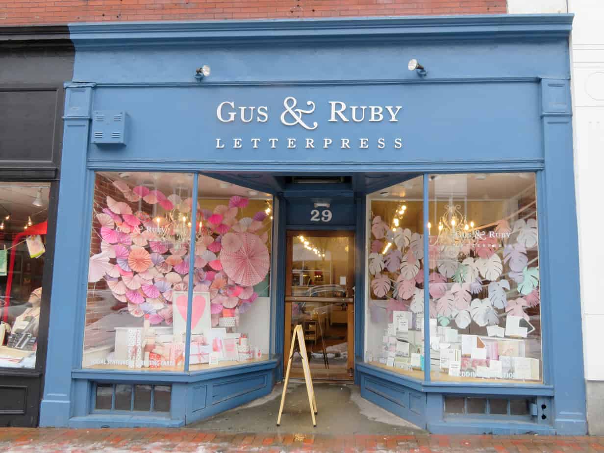 A storefront with big windows filled with flowers in Portsmouth New Hampshire