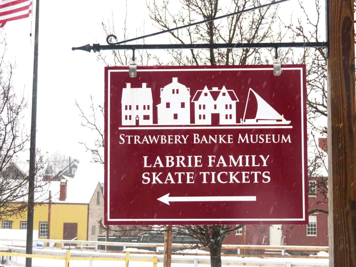 A red sign with an arrow and reading \"Labrie Family Skate Tickets\" in Portsmouth New Hampshire
