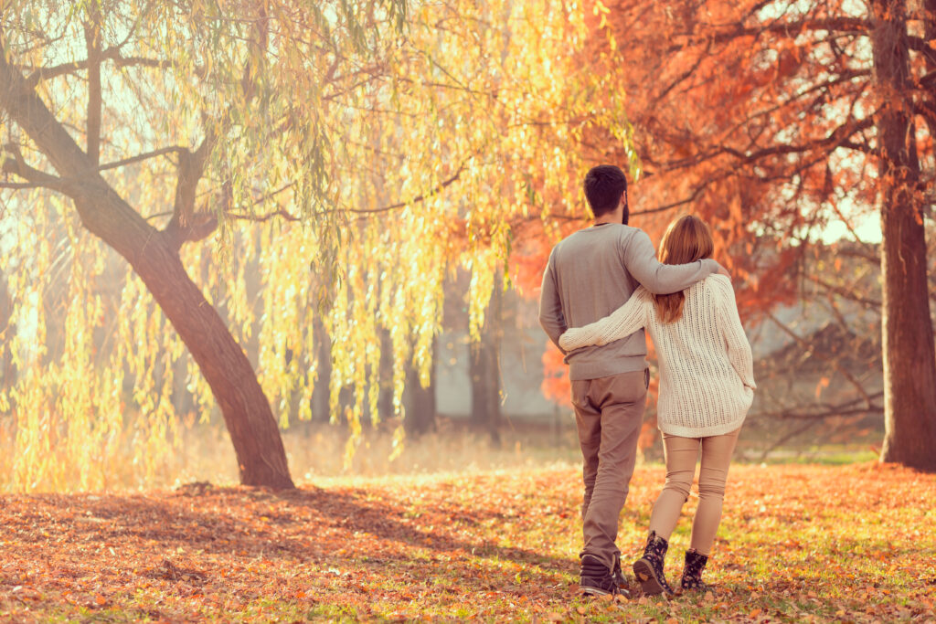 A couple on a fall date admire fall foliage