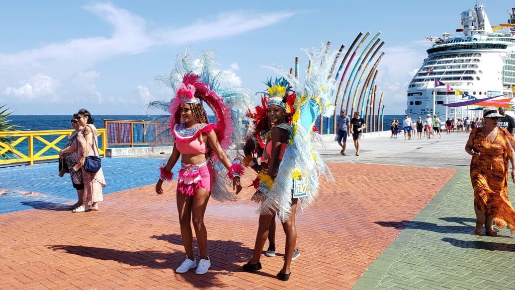 People in costumes stand on a redbrick walkway.