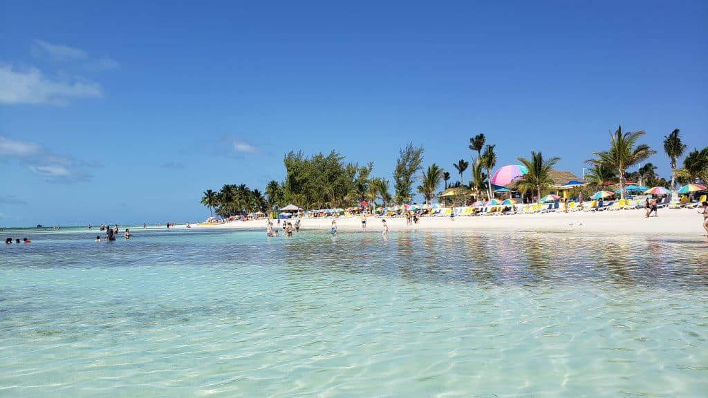 People relaxing on the ocean which is clear.