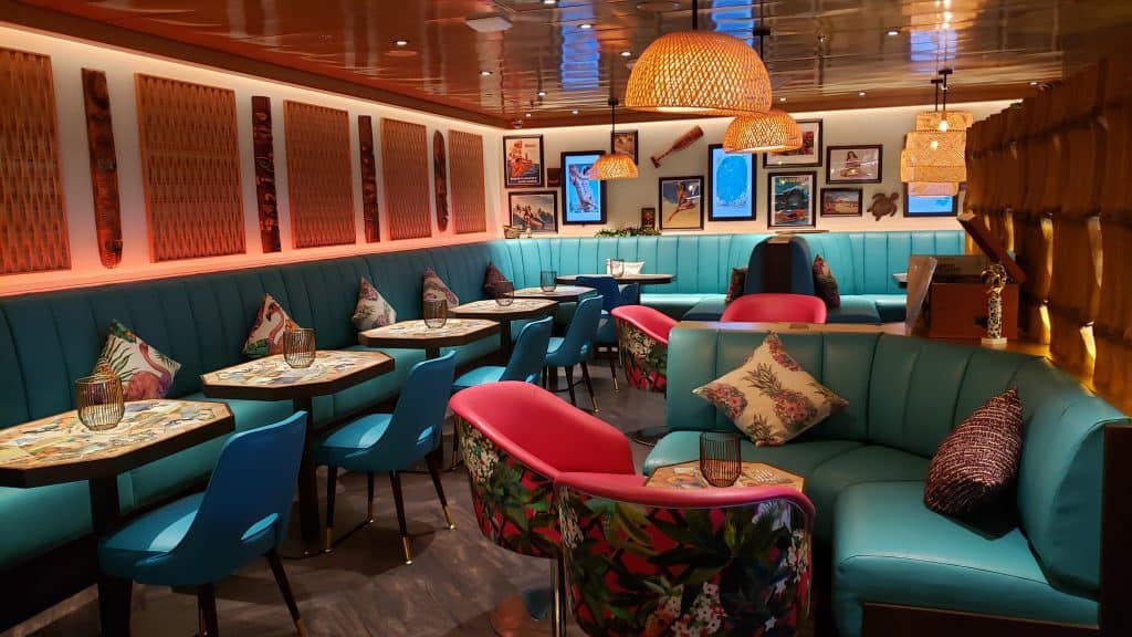 An empty dining area with blue and red chairs.