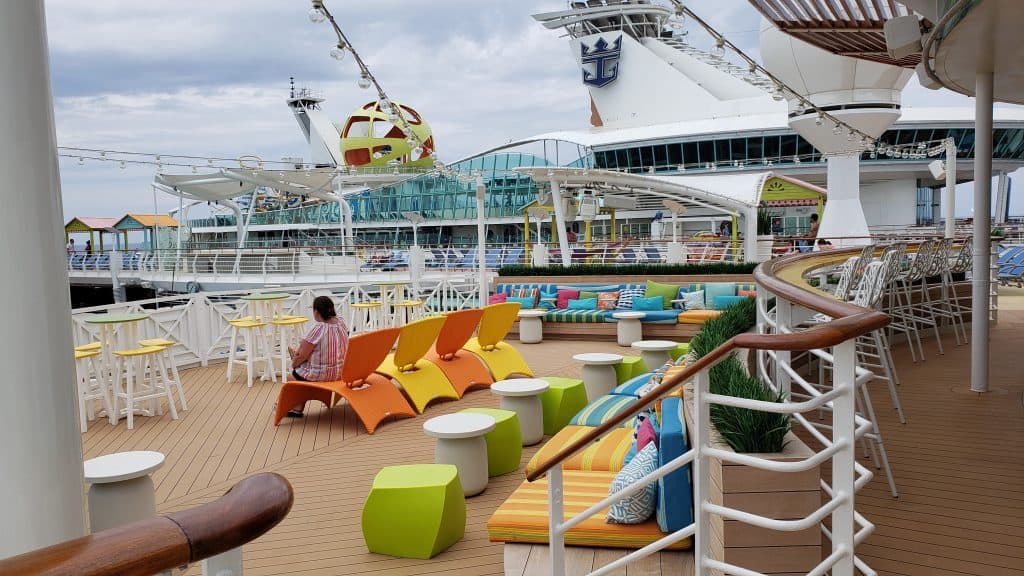 People are relaxing on the deck of a cruise ship.