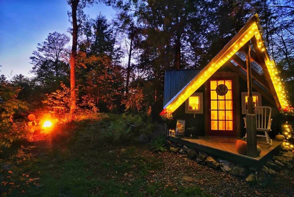 Mountain cabin lit up at night