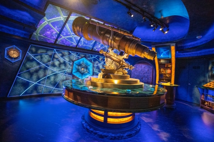 A giant spyglass in a blue room.