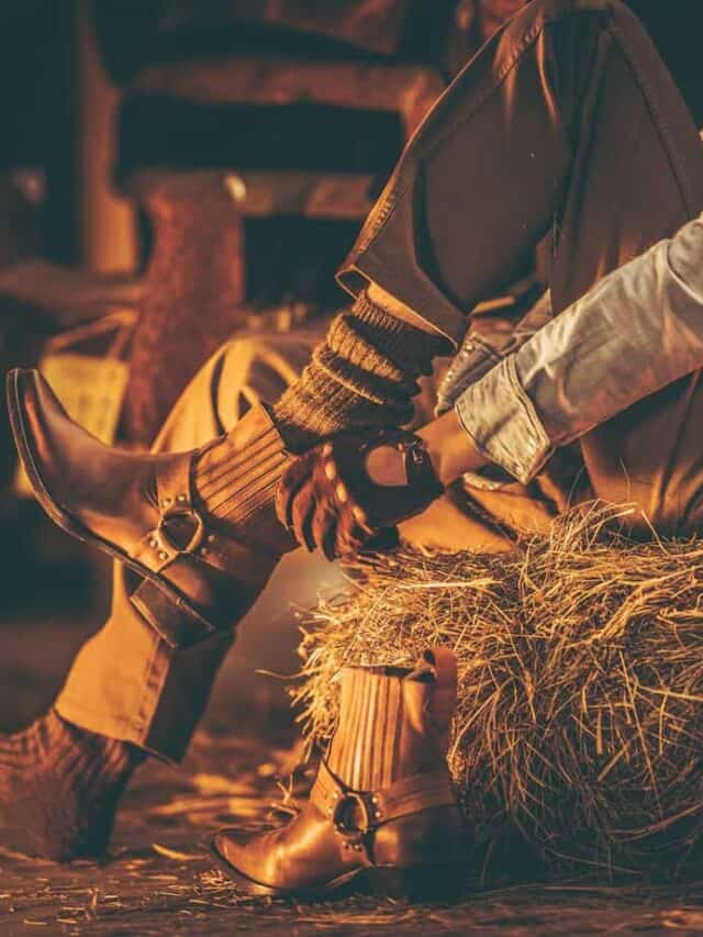 romantic things to do in nashville cover - Cowboy in the Barn Wearing Boots While Seating on the Pile of Hay. American Farming Theme