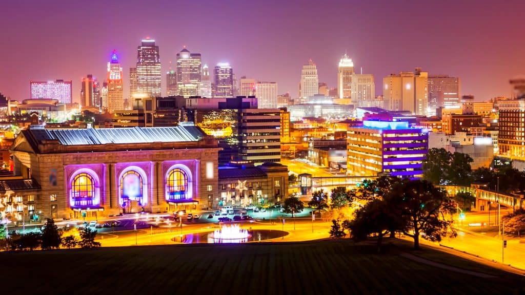 Colorful city skyline at night with neon lights.