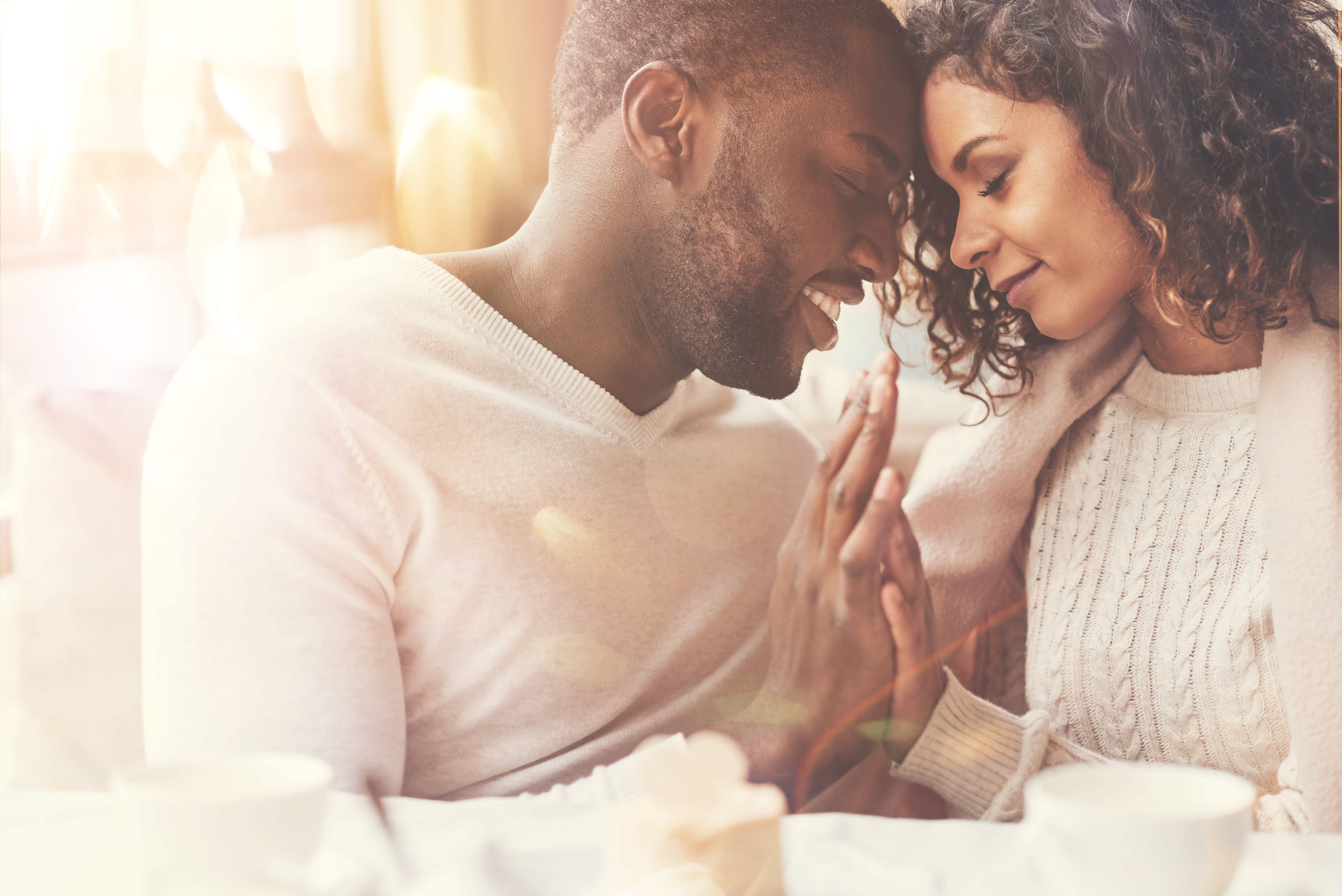 how to strengthen your marriage daily - image of african american couple putting heads together in love at breakfast table