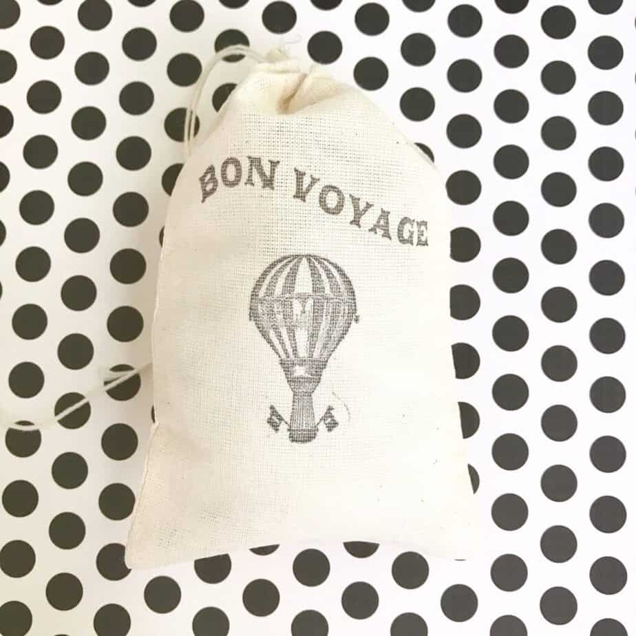 A white back has a hot air balloon with text reading Bon Voyage.