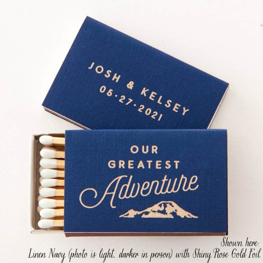 A blue match book says Our Greatest Adventure with the couple\'s name and wedding date on the back.