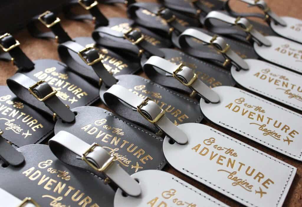Small leather keychains say & so the adventure begins.