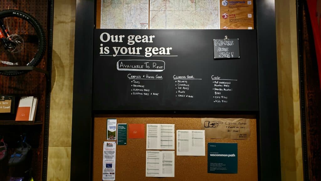 Signs hanging up on a bulletin board that says Our gear is your gear.