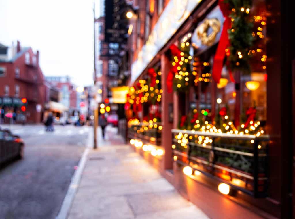 A blurry image of Christmas decorates on front of a store.