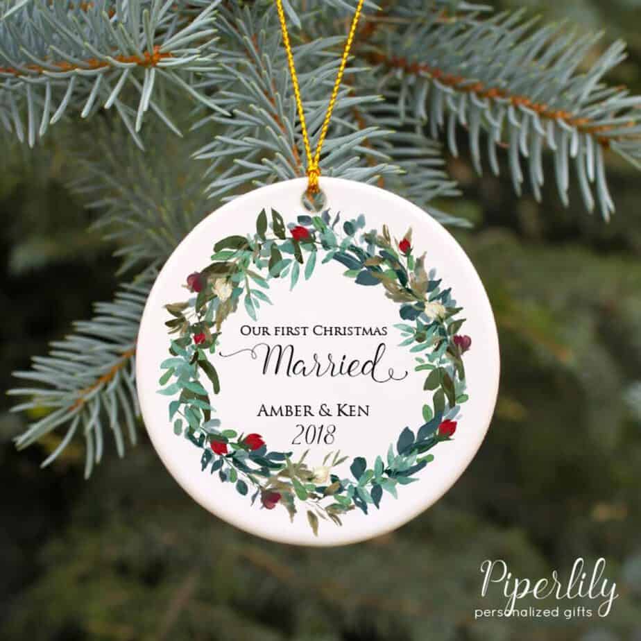 Christmas ornament hanging on a tree that says \"Our first Christmas married. Amber & Ken 2018.\"