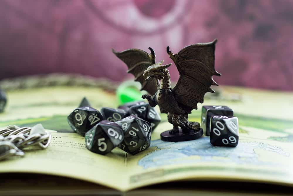 Close up of a dragon token and dice.