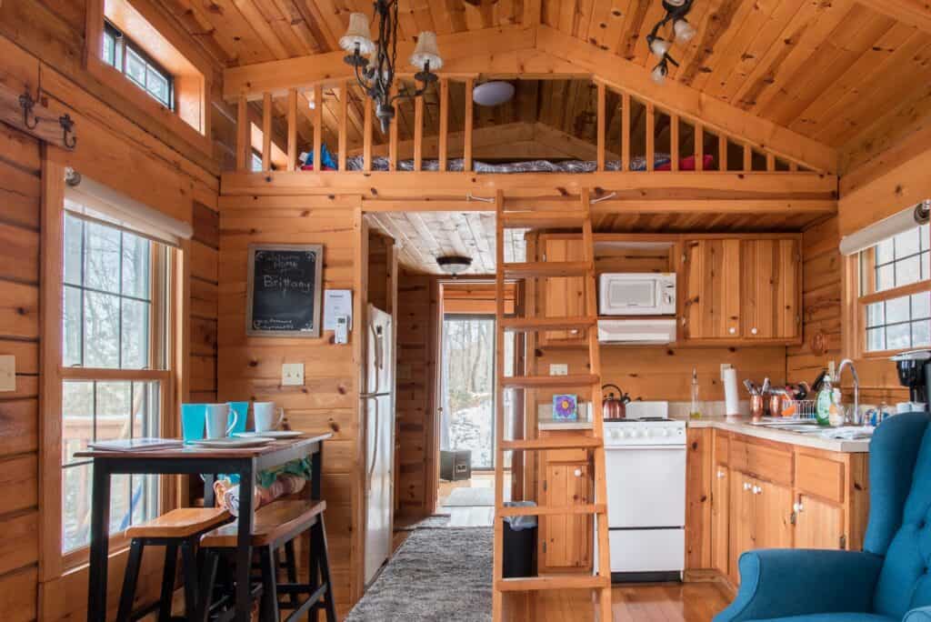 Interior of a wooden cabin living room and kitchen.