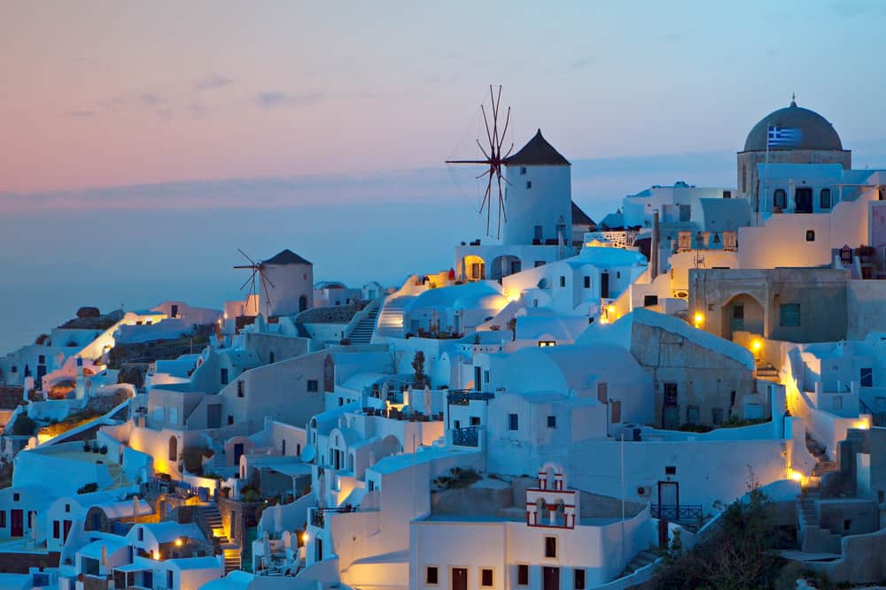 White buildings near the ocean at sunset.