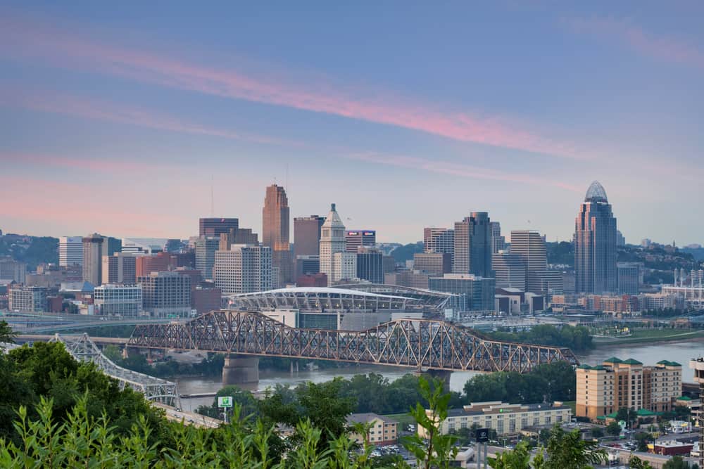 Aerial view of a city skyline with a bridge stretching across the water.