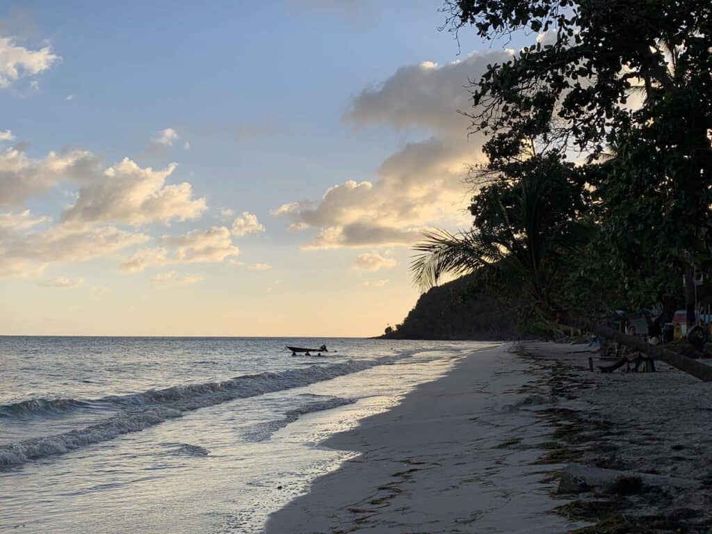 Empty beach under a sunset sky.