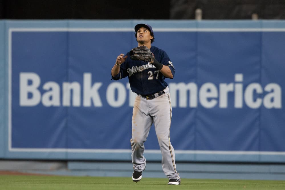 A baseball player gets ready to catch a ball on the field.