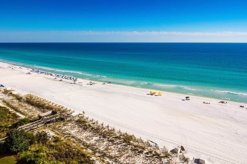 Destin, Florida - Oct. 24, 2014: Beach goers enjoy the white sandy beaches and emerald blue waters of the panhandle in Destin, Florida. Originating as a small fishing village, it is now a popular tourist destination.