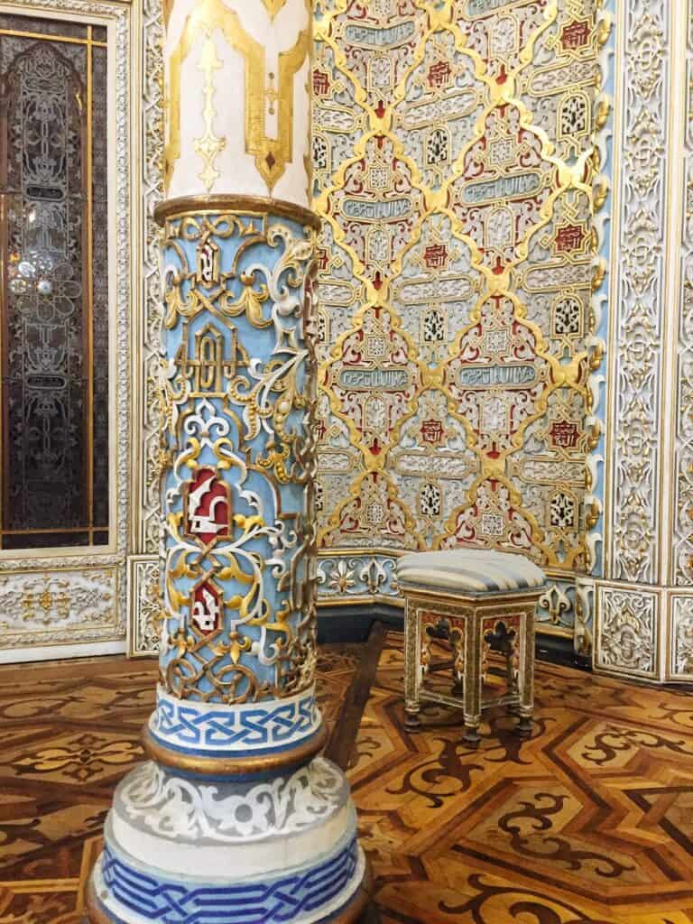 A unique column with blue, yellow, red, and white accents on it.