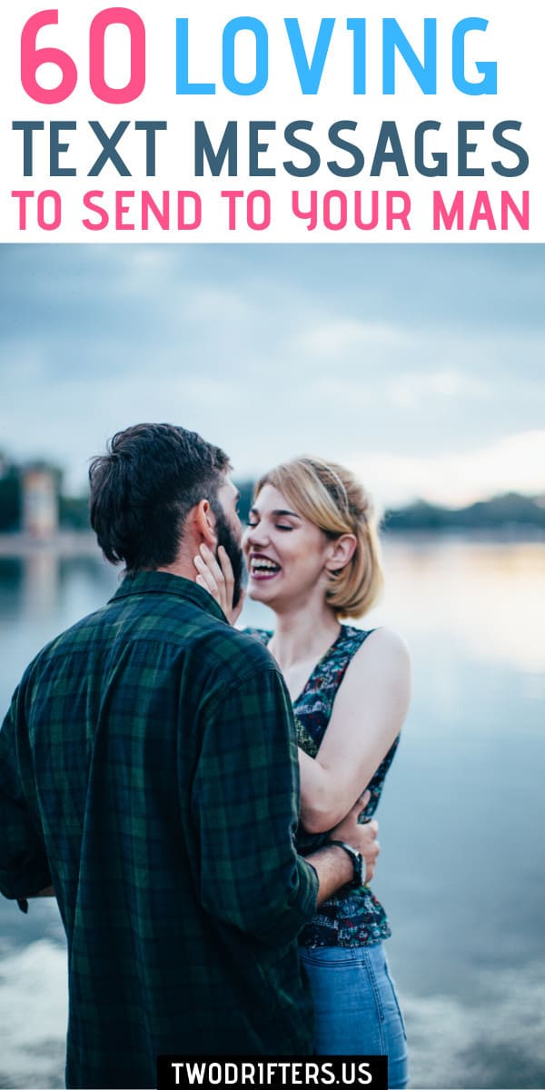 A couple laughs while about to kiss with water behind them.