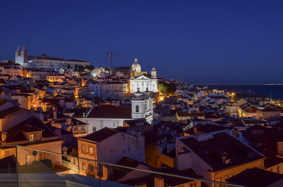 A deep blue sky over a city at night in one of the best romantic getaway spots in the world