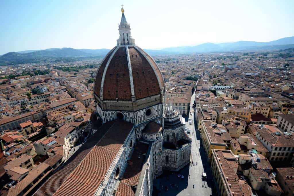 The top of a cathedral overlooking a European city. 