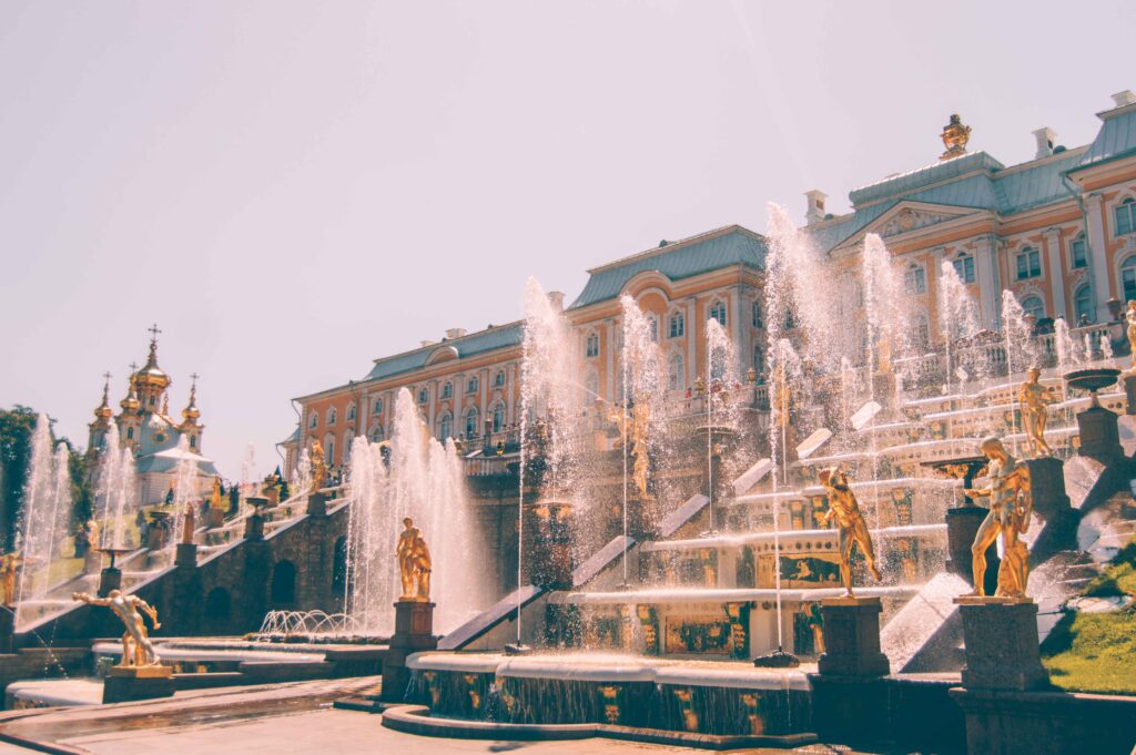 Fountains spray water at a palace at one of the understated European romantic destinations.