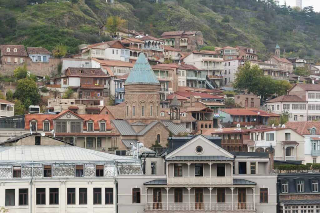 A large hillside with various buildings covering the side of it. 