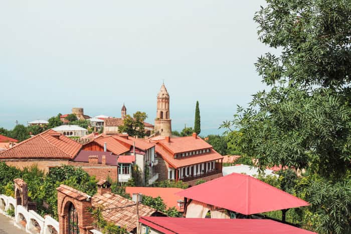 View of red town buildings under a blue sky.