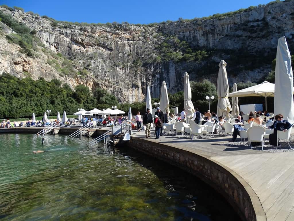 People dining at a restaurant by the water.