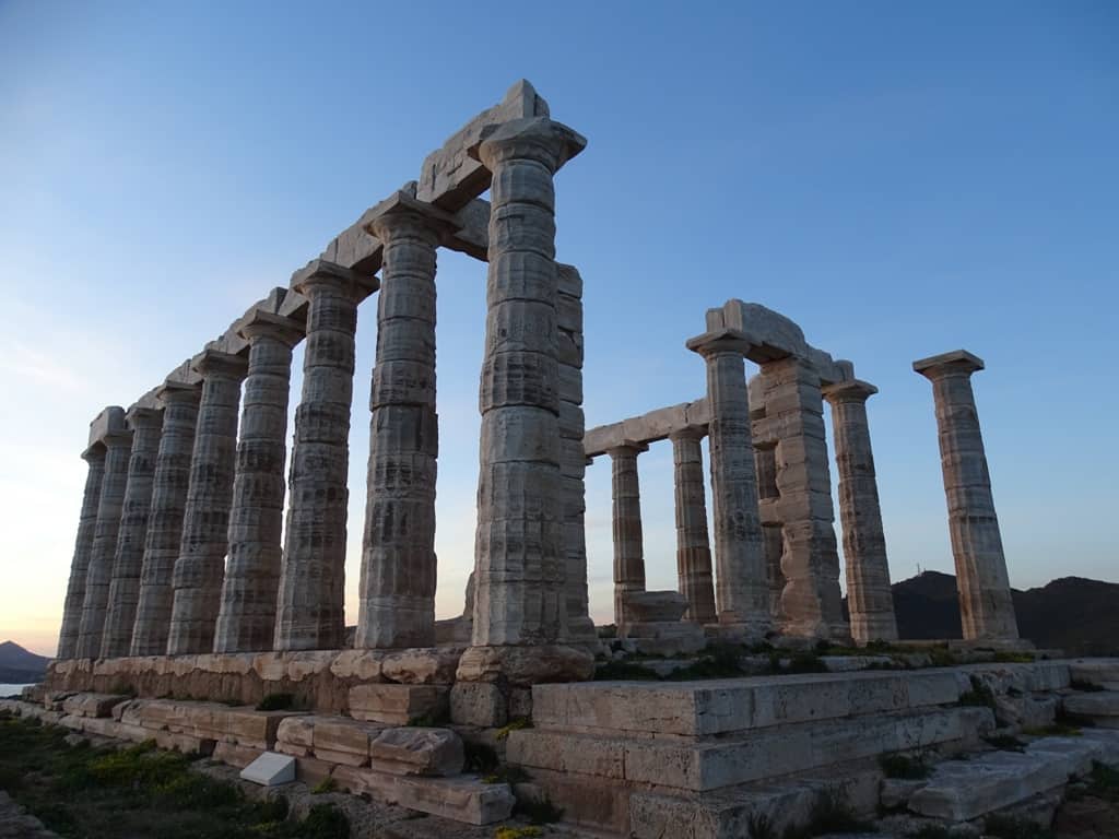 Tall columns on a structure under a blue sky.