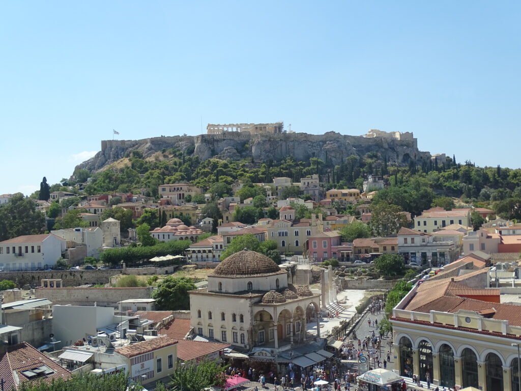 Aerial view of a town with historic architecture under a blue sky.