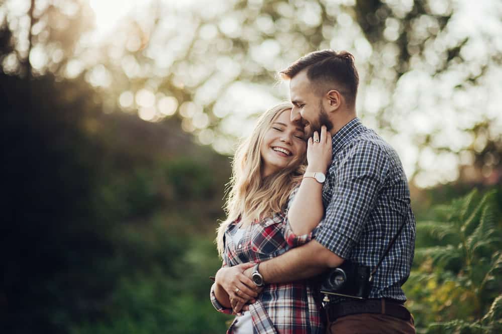 Happy young couple in mountain. Hipster couple in love having fun together.