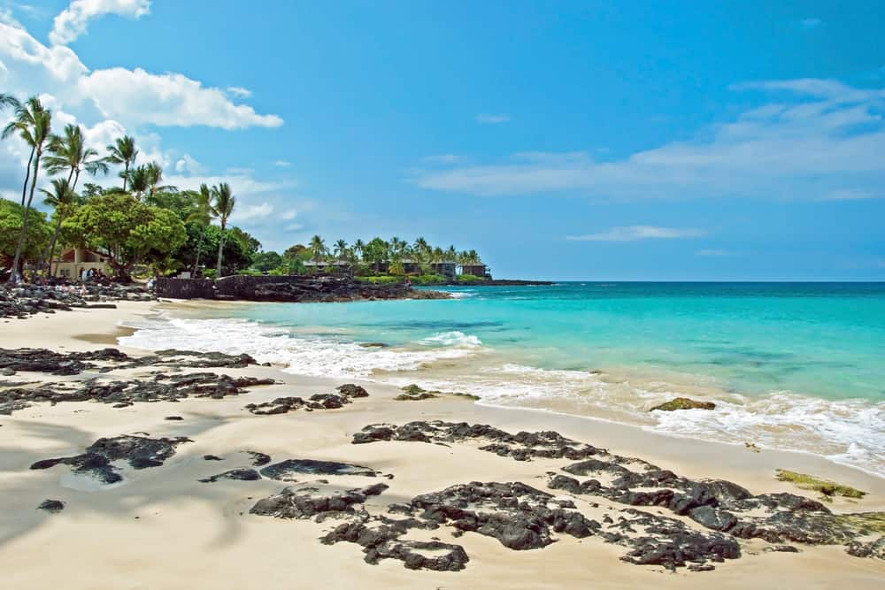 Rocks on a beach with turquoise waters. 