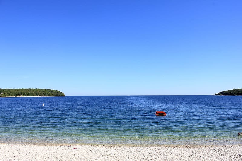 A calm blue ocean under a clear sky.