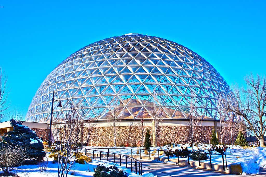Large glass dome under a blue sky in winter.