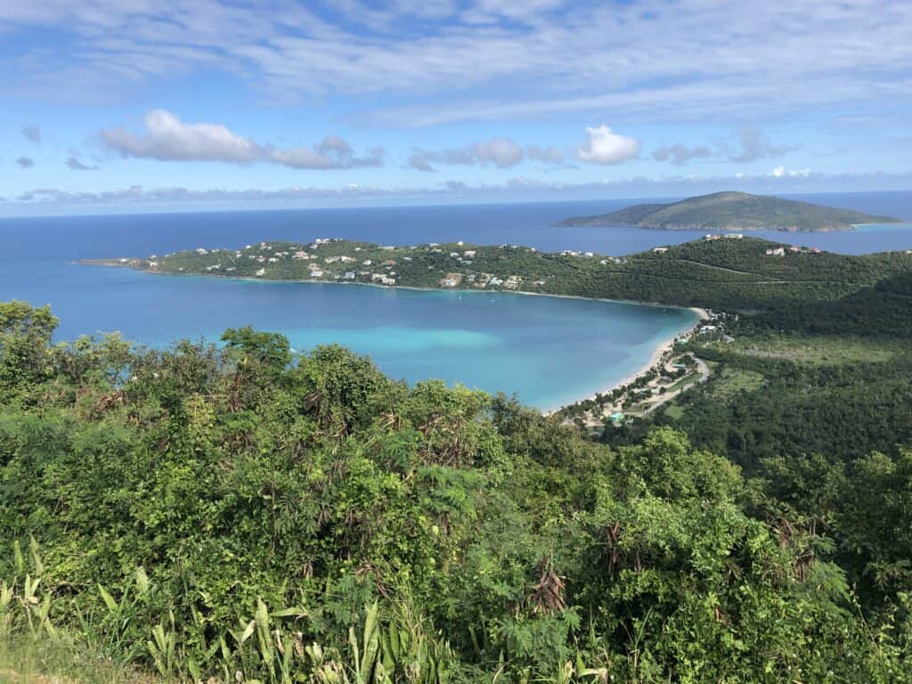 View of a blue body of water surrounded by plush greenery.